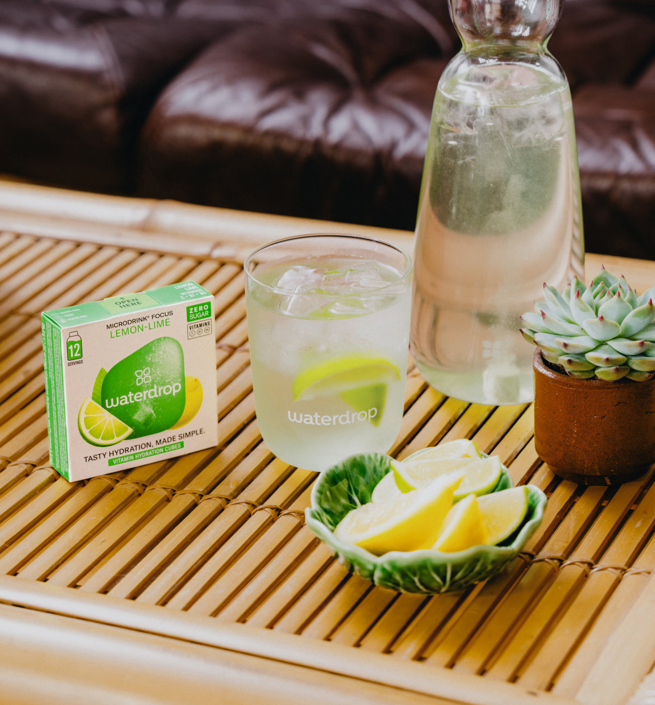 LEMON-LIME Microdrink with glass and citrus on bamboo tray.